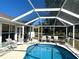 Screened pool area with patio furniture and grill at 16161 Juarez Cir, Punta Gorda, FL 33955