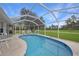 Inviting screened pool area with patio furniture, overlooking a large backyard at 16161 Juarez Cir, Punta Gorda, FL 33955