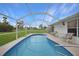 Screened pool and patio with lush green backyard at 16161 Juarez Cir, Punta Gorda, FL 33955