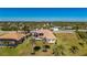 An aerial view showcasing a large home, pool, and expansive lot at 17557 Ohara Dr, Port Charlotte, FL 33948