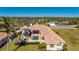 Aerial view of a home with pool and spa; a large lot with tropical landscaping at 17557 Ohara Dr, Port Charlotte, FL 33948