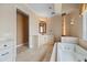 Spa-like bathroom featuring a corner vanity and a deep soaking tub at 17557 Ohara Dr, Port Charlotte, FL 33948