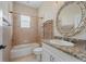 Clean bathroom with a tub, toilet and granite countertop at 17557 Ohara Dr, Port Charlotte, FL 33948