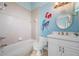 Bathroom with a tub, toilet, and vanity with a mermaid mural at 17557 Ohara Dr, Port Charlotte, FL 33948