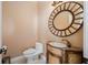 Powder room with ornate vanity and a large circular mirror at 17557 Ohara Dr, Port Charlotte, FL 33948