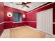 Red bedroom with a ceiling fan and double closet at 17557 Ohara Dr, Port Charlotte, FL 33948