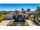 Two-story home with tile roof, palm trees, and driveway at 17557 Ohara Dr, Port Charlotte, FL 33948