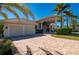 Two-story house with a two-car garage and palm trees at 17557 Ohara Dr, Port Charlotte, FL 33948