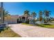 Two-story house with a large driveway, two-car garage, and lush landscaping at 17557 Ohara Dr, Port Charlotte, FL 33948