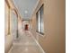 Long hallway with tile floors and arched doorways at 17557 Ohara Dr, Port Charlotte, FL 33948