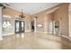 Living room with high ceilings, a chandelier, and marble floors at 17557 Ohara Dr, Port Charlotte, FL 33948