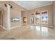 Living room with high ceilings, a view of the pool, and marble floors at 17557 Ohara Dr, Port Charlotte, FL 33948