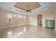 Primary bedroom with travertine floors and access to a patio at 17557 Ohara Dr, Port Charlotte, FL 33948