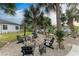 Firepit and seating area in a spacious backyard with palm trees at 1763 Oakland Rd, North Port, FL 34286