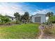 Landscaped backyard with a metal storage shed at 1763 Oakland Rd, North Port, FL 34286