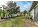 Landscaped backyard with tropical plants and a white fence at 1763 Oakland Rd, North Port, FL 34286