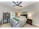 Bedroom with floral bedding, ceiling fan, and wood-look floors at 1763 Oakland Rd, North Port, FL 34286