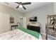 Bedroom with a mounted TV, dresser, and ceiling fan at 1763 Oakland Rd, North Port, FL 34286