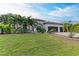 Modern home exterior with three-car garage and landscaping at 1763 Oakland Rd, North Port, FL 34286