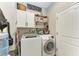 Bright laundry room with washer, dryer, and ample storage at 1763 Oakland Rd, North Port, FL 34286