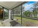 Screened porch with view of lush backyard and patio furniture at 1763 Oakland Rd, North Port, FL 34286