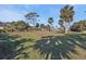 Spacious backyard with a volleyball net and lush landscaping at 18500 Ohara Dr, Port Charlotte, FL 33948