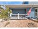 Charming front porch with rocking chairs and American flag at 18500 Ohara Dr, Port Charlotte, FL 33948