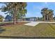 Landscaped front yard with palm trees and a large house at 18500 Ohara Dr, Port Charlotte, FL 33948