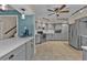 Modern kitchen with gray cabinets, quartz countertops, and stainless steel appliances at 18500 Ohara Dr, Port Charlotte, FL 33948