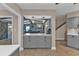 Kitchen with gray cabinets, quartz countertops and view into living room at 18500 Ohara Dr, Port Charlotte, FL 33948