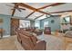 Spacious living area with exposed beams, fireplace and comfortable seating at 18500 Ohara Dr, Port Charlotte, FL 33948