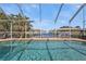 Inviting pool area with screened enclosure, offering water views at 18500 Ohara Dr, Port Charlotte, FL 33948