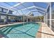 Sparkling pool with screened enclosure and patio at 18500 Ohara Dr, Port Charlotte, FL 33948