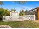 White picket fence encloses a lush green backyard at 201 Champion St, Port Charlotte, FL 33953