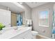 Bathroom with white vanity, shower, and window at 201 Champion St, Port Charlotte, FL 33953