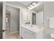 White vanity, mirror, and tile flooring in bathroom at 201 Champion St, Port Charlotte, FL 33953