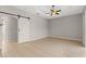 Bright bedroom with wood-look tile flooring and ceiling fan at 201 Champion St, Port Charlotte, FL 33953