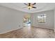 Spacious bedroom with wood-look tile floors, ceiling fan, and pool view at 201 Champion St, Port Charlotte, FL 33953