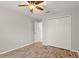 Bedroom with double door closet and wood-look tile floor at 201 Champion St, Port Charlotte, FL 33953