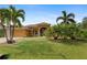 Tan house with a screened porch and attached garage at 201 Champion St, Port Charlotte, FL 33953