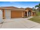 Tan house with a screened porch and attached garage at 201 Champion St, Port Charlotte, FL 33953