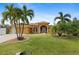 Attractive single-story home with palm trees and landscaped yard at 201 Champion St, Port Charlotte, FL 33953