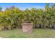 Brick fire pit surrounded by tropical landscaping at 201 Champion St, Port Charlotte, FL 33953