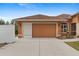 Attached garage with a tan exterior and screen door at 201 Champion St, Port Charlotte, FL 33953