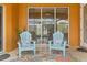 Peaceful patio with two light blue chairs and side table at 201 Champion St, Port Charlotte, FL 33953