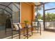 Cozy patio with two black chairs, side table and pillows at 201 Champion St, Port Charlotte, FL 33953