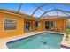 Relaxing pool area with patio and covered lanai at 201 Champion St, Port Charlotte, FL 33953