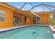 Refreshing pool with tiled deck and covered lanai at 201 Champion St, Port Charlotte, FL 33953