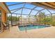 Inviting screened pool with spacious patio and lush landscaping at 201 Champion St, Port Charlotte, FL 33953