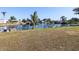 Spacious backyard with canal views and tropical landscaping at 21094 Edgewater Dr, Port Charlotte, FL 33952